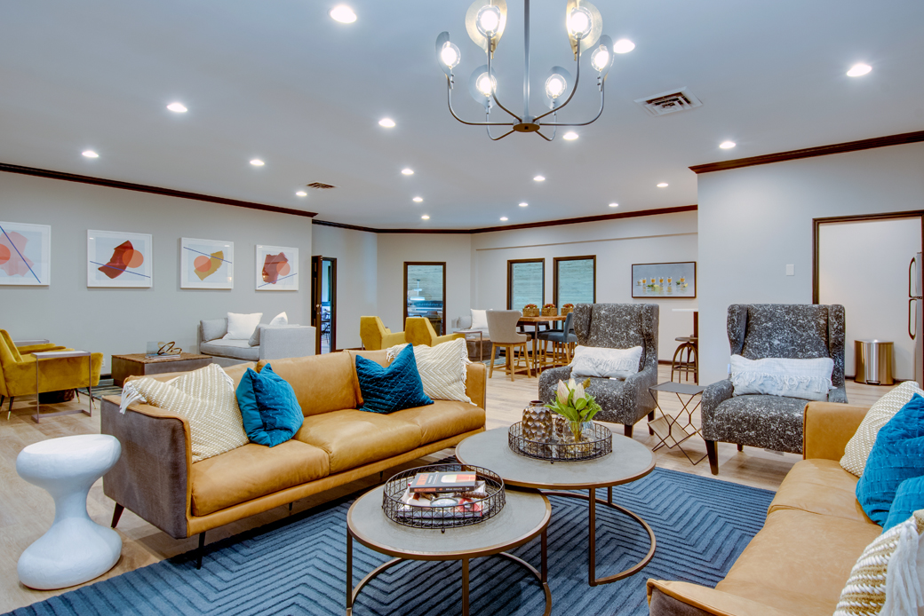 living room with black couch and decorative shelves