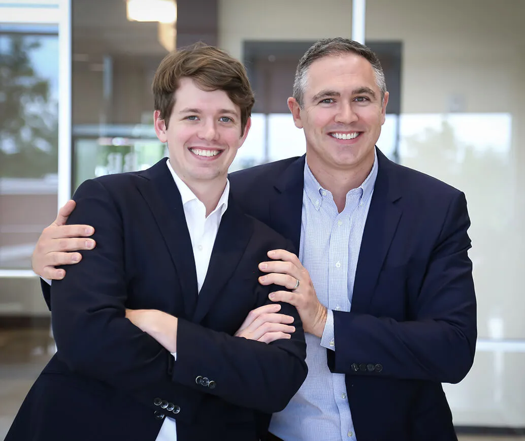 Two people standing in business casual attire