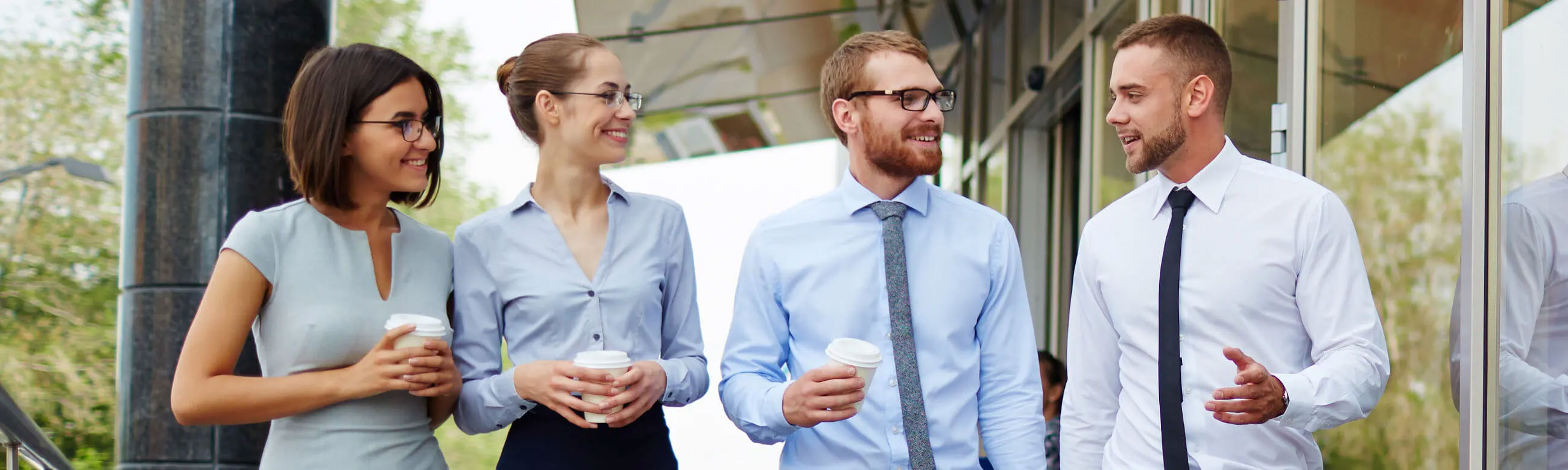 4 associates having a discussion over coffee
