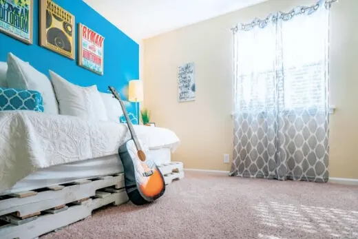Daybed in bedroom with an acoustic guitar