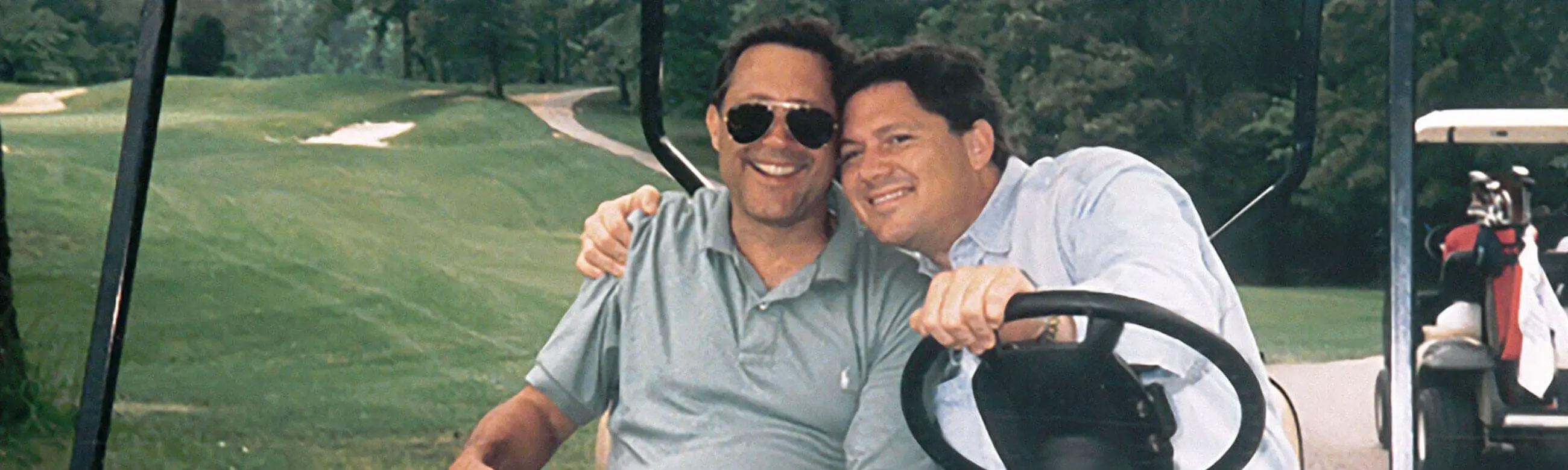 2 men in a golf cart